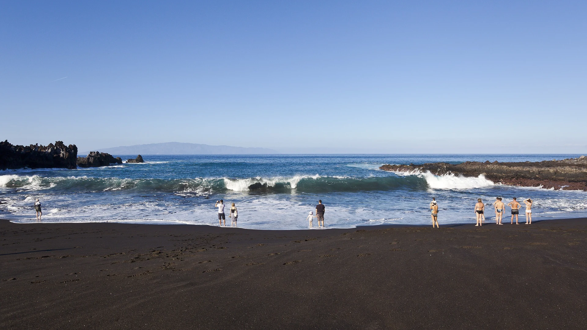 The seafront and dark volcanic coastline at Puerto de Santiago on Tenerife's west coast