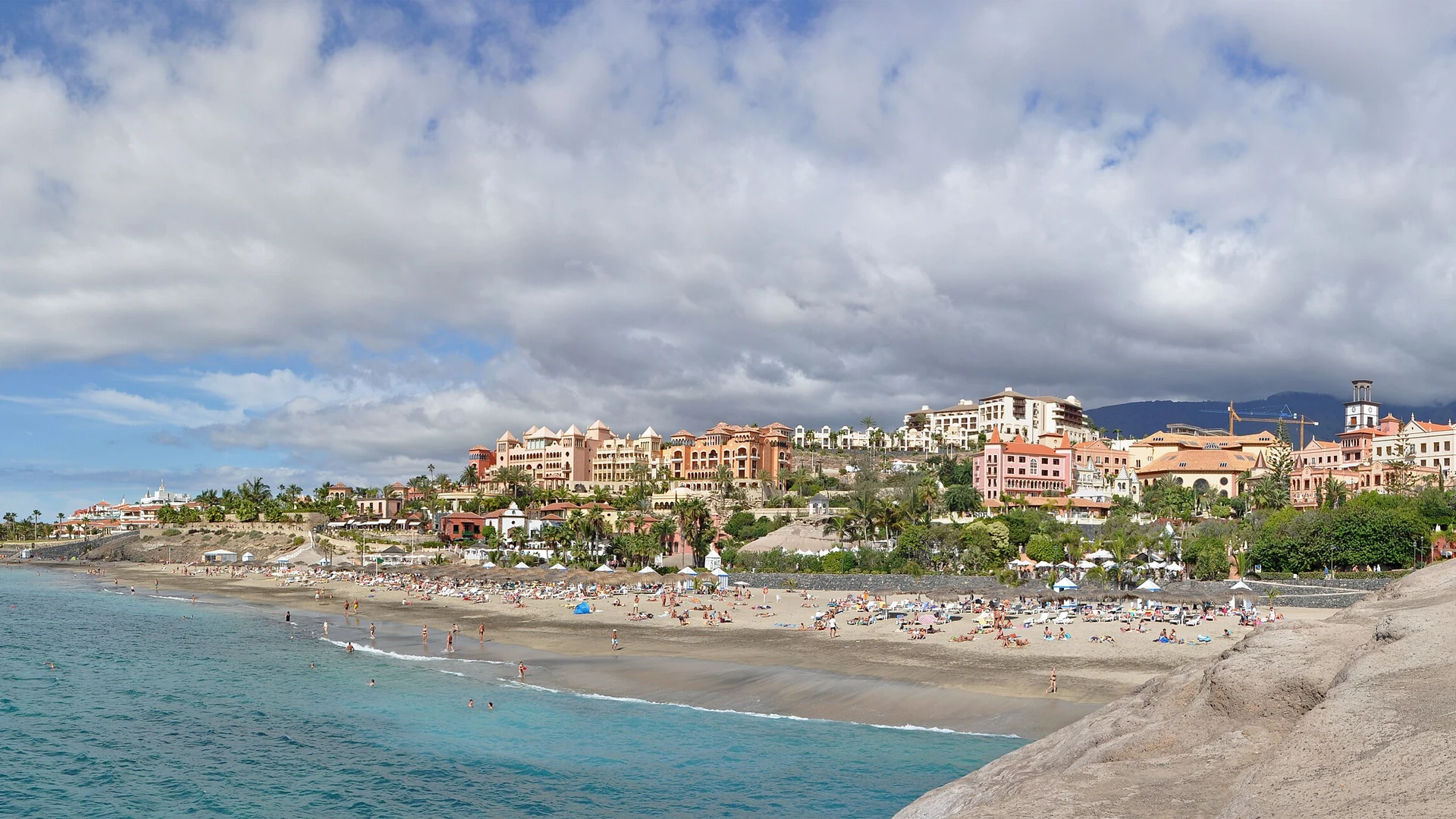 The sheltered sand and hotel frontage of Playa del Duque in Costa Adeje, Tenerife
