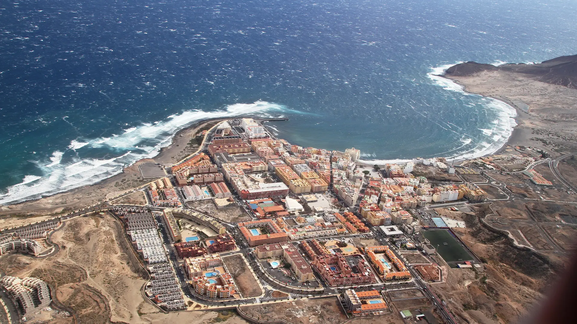 The beach and promenade at El Médano with Montaña Roja rising behind, southern Tenerife