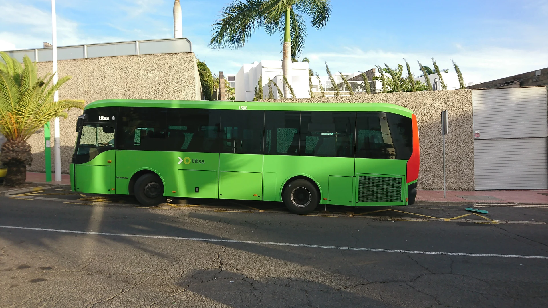 A green TITSA bus at a stop in Costa Adeje, southern Tenerife