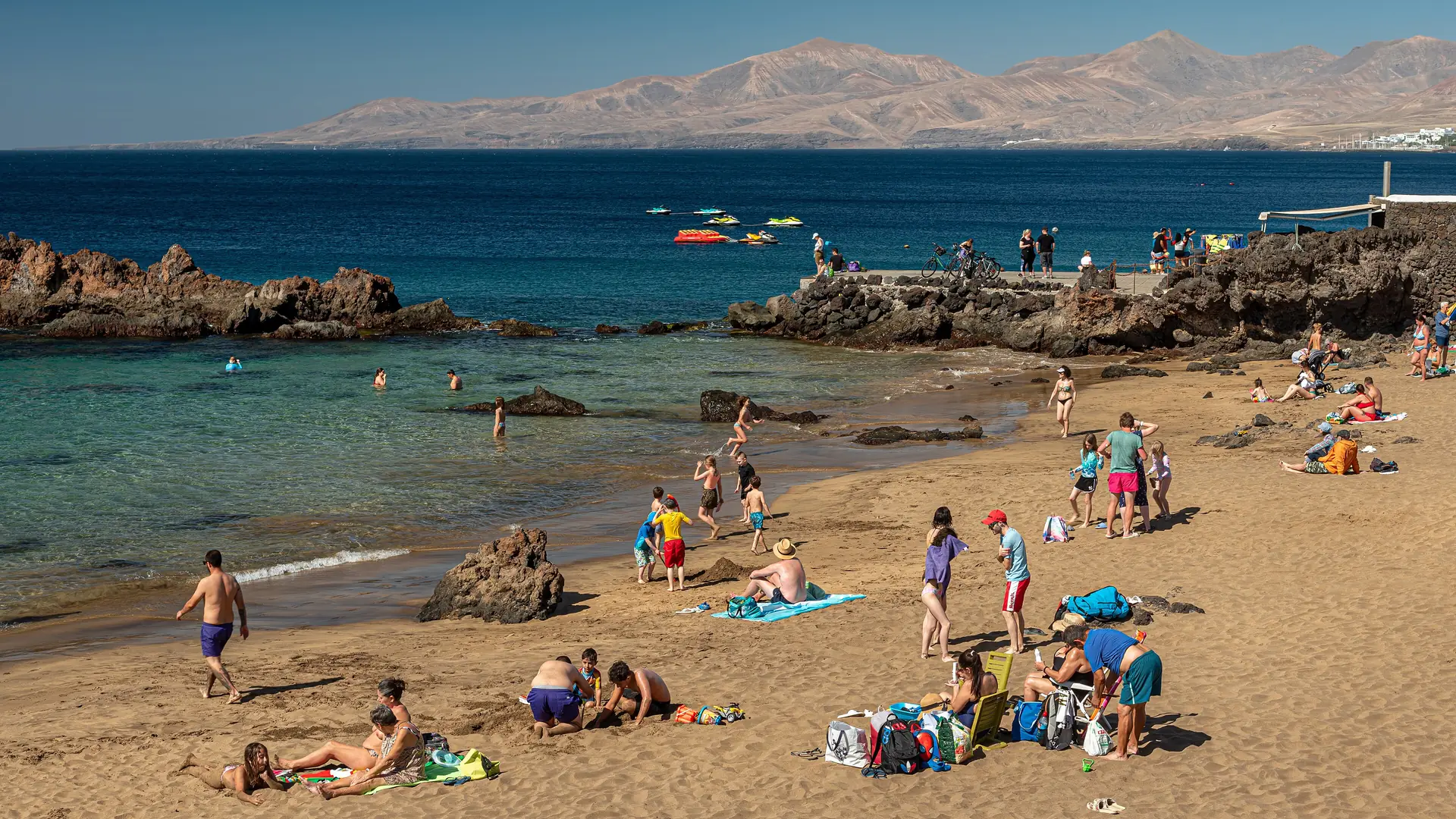 Playa Chica in Puerto del Carmen, Lanzarote, a small sandy cove between volcanic rocks where beginner dives start from the shore