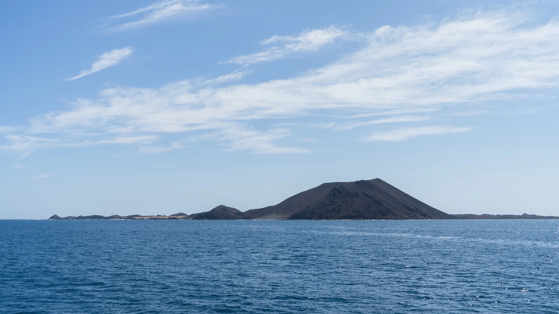 Lobos Island and its volcanic cone seen across the sea from the ferry between Playa Blanca and Corralejo
