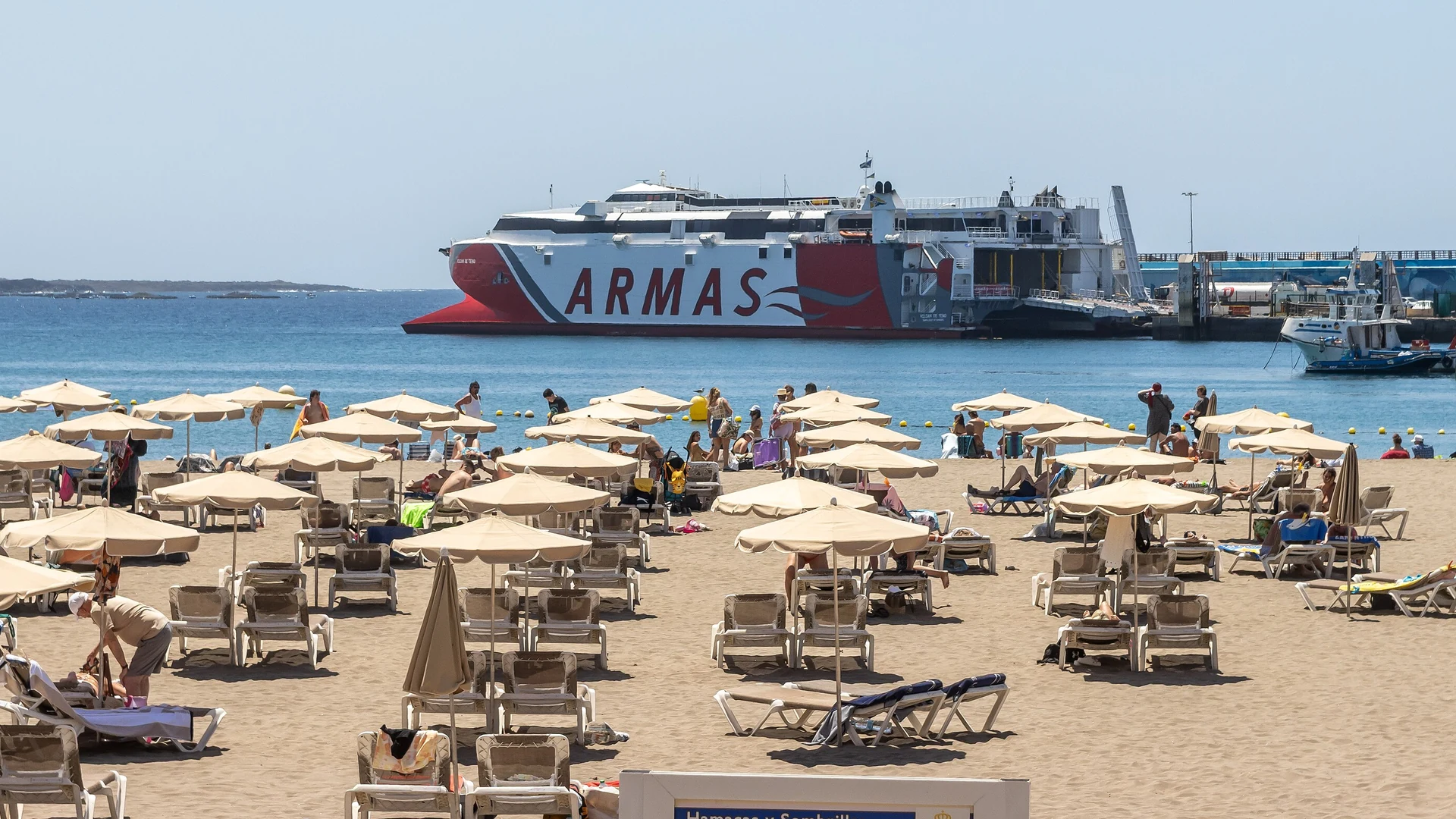 Ferries berthed at the port of Los Cristianos with the beach and town behind, southern Tenerife