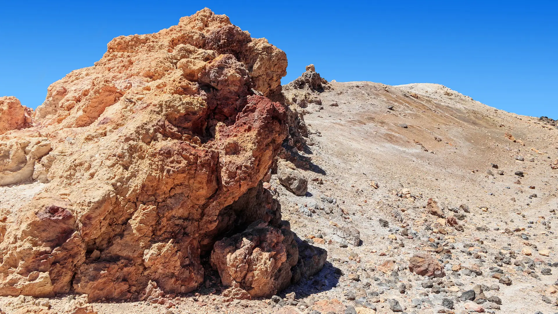 The volcanic summit cone of Mount Teide above the Roques de García rock formations, Tenerife