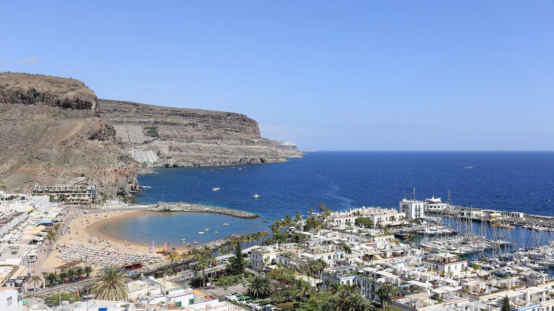 Puerto de Mogán from above, with the beach, the marina and the white village beneath the cliffs of south-west Gran Canaria