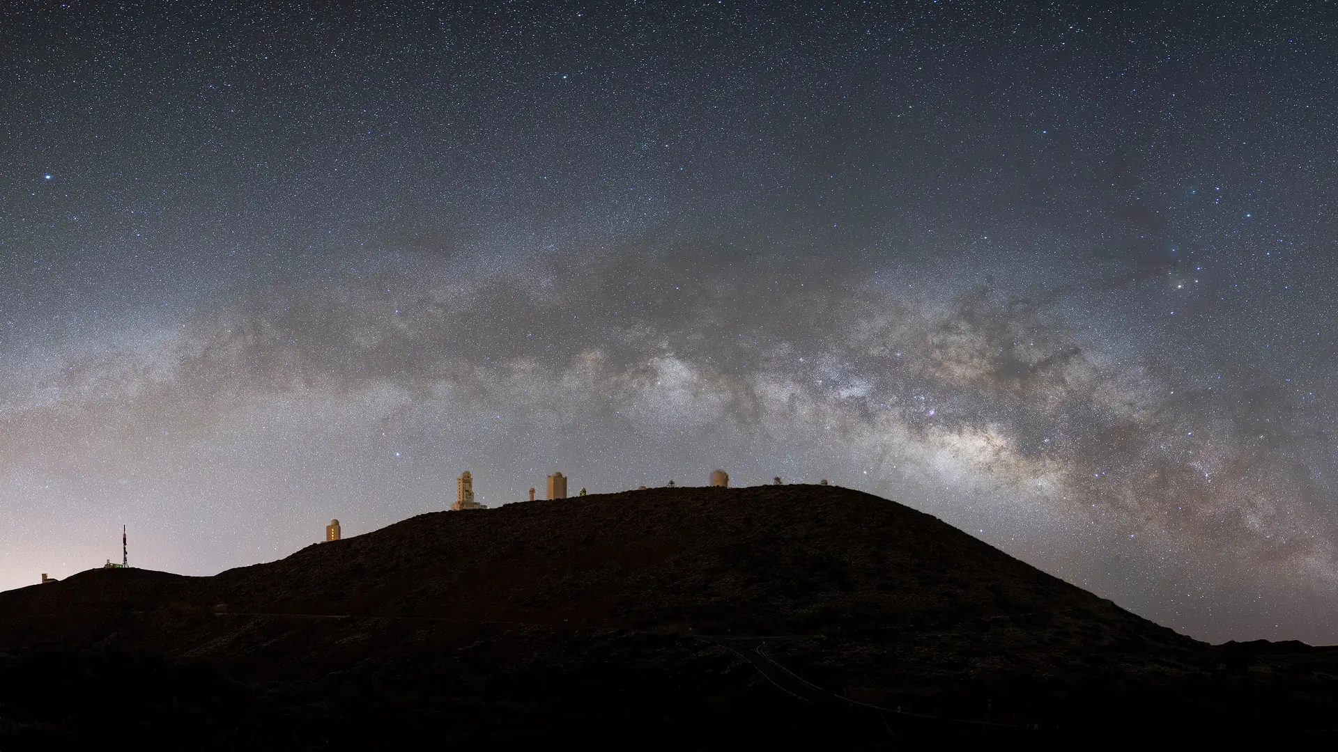 The Milky Way arching over the domes of the Teide Observatory in Teide National Park, Tenerife