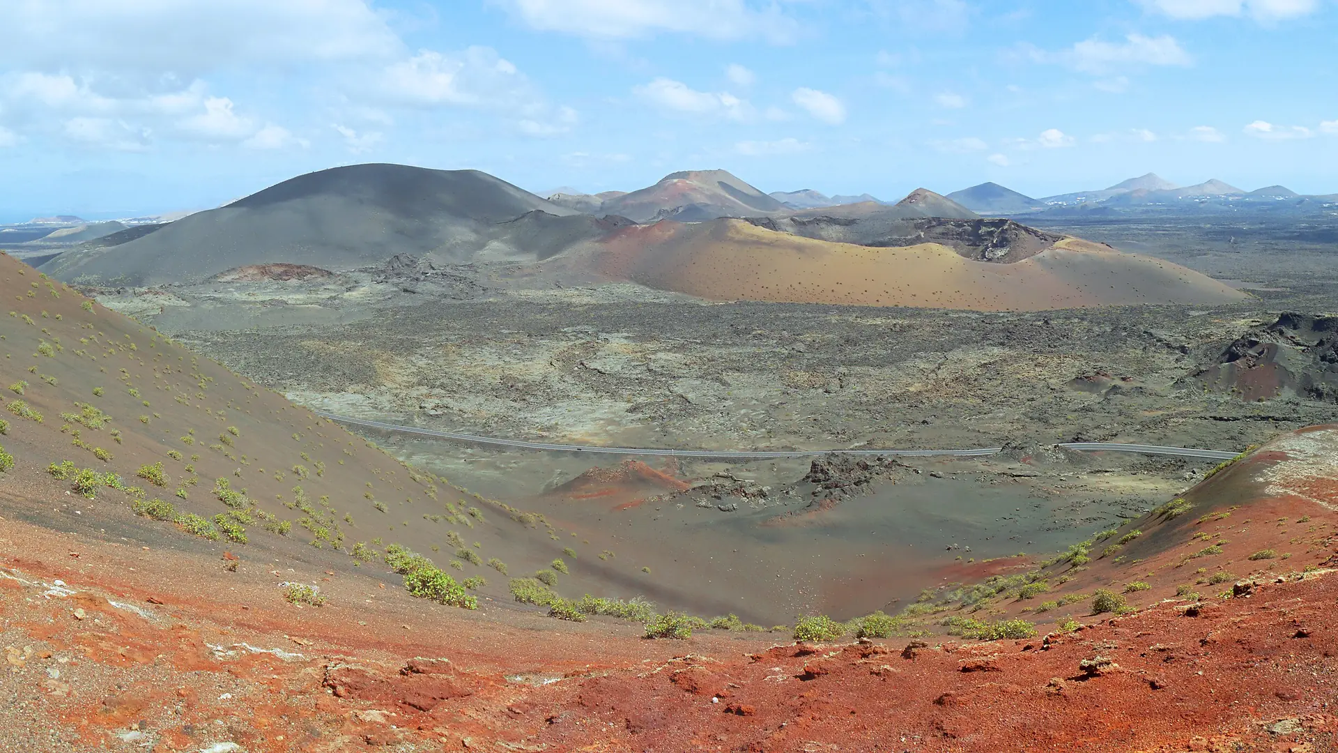 Red volcanic ash slopes and cinder cones around the Caldera del Corazoncillo in the Timanfaya volcanic area, Lanzarote